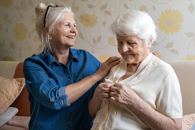 middle stages of Alzheimer's senior daughter caring for senior